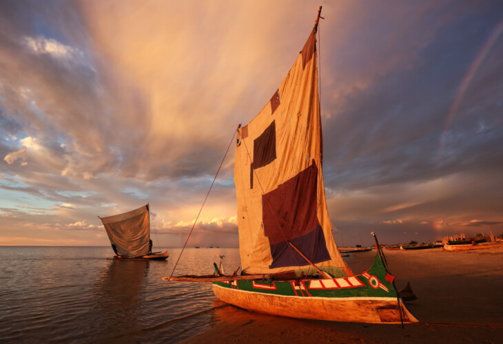 Traditional fishing pirogue at sunset with dramatic sky after a